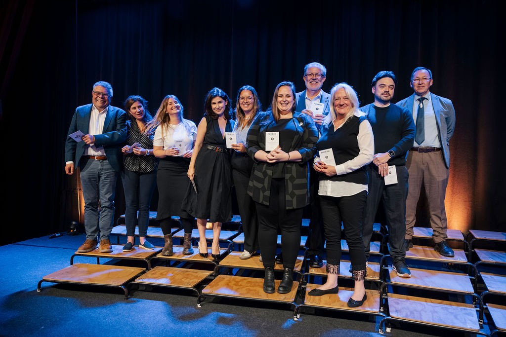 AECO Puffin Pin recipients, including Daniela Castelo of Mystic Cruises, on stage in Oslo